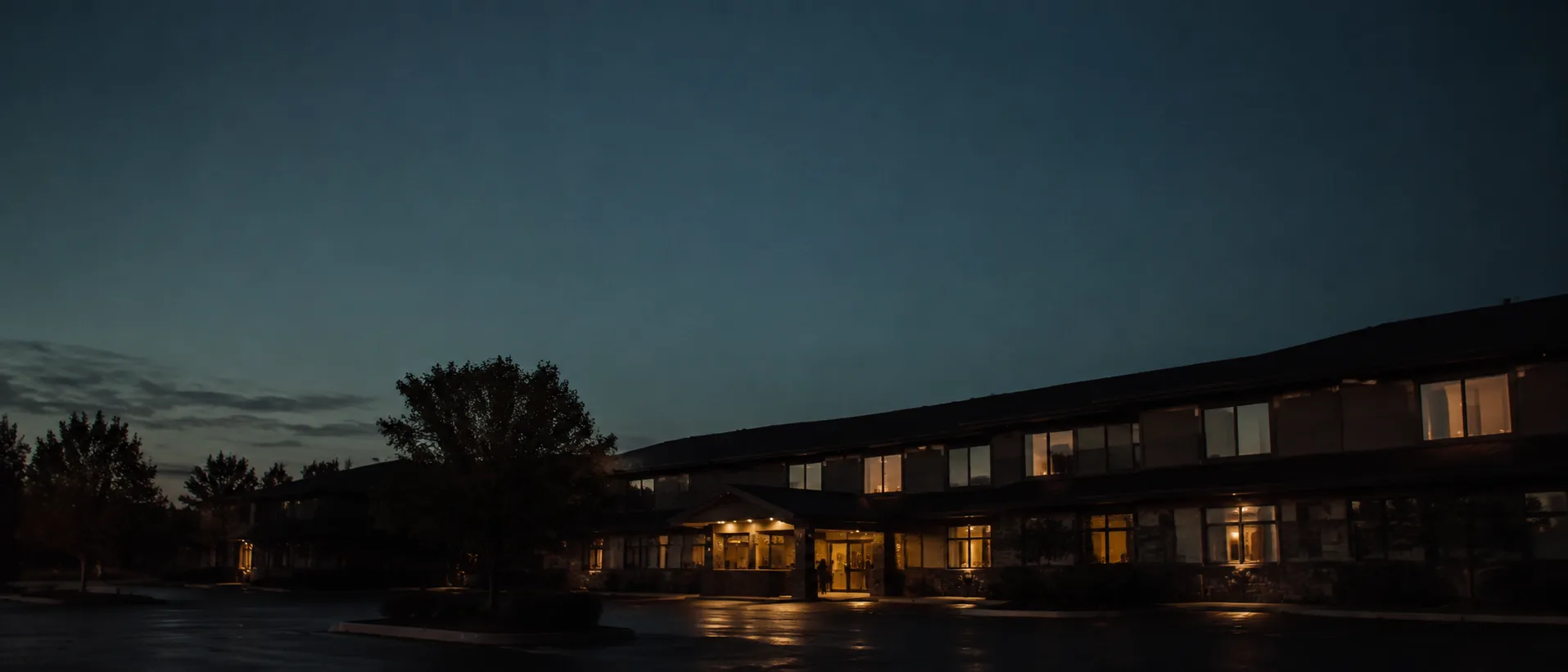 A welcoming hotel glowing at dusk